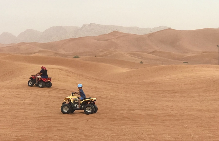 kid riding quad in dubai desert